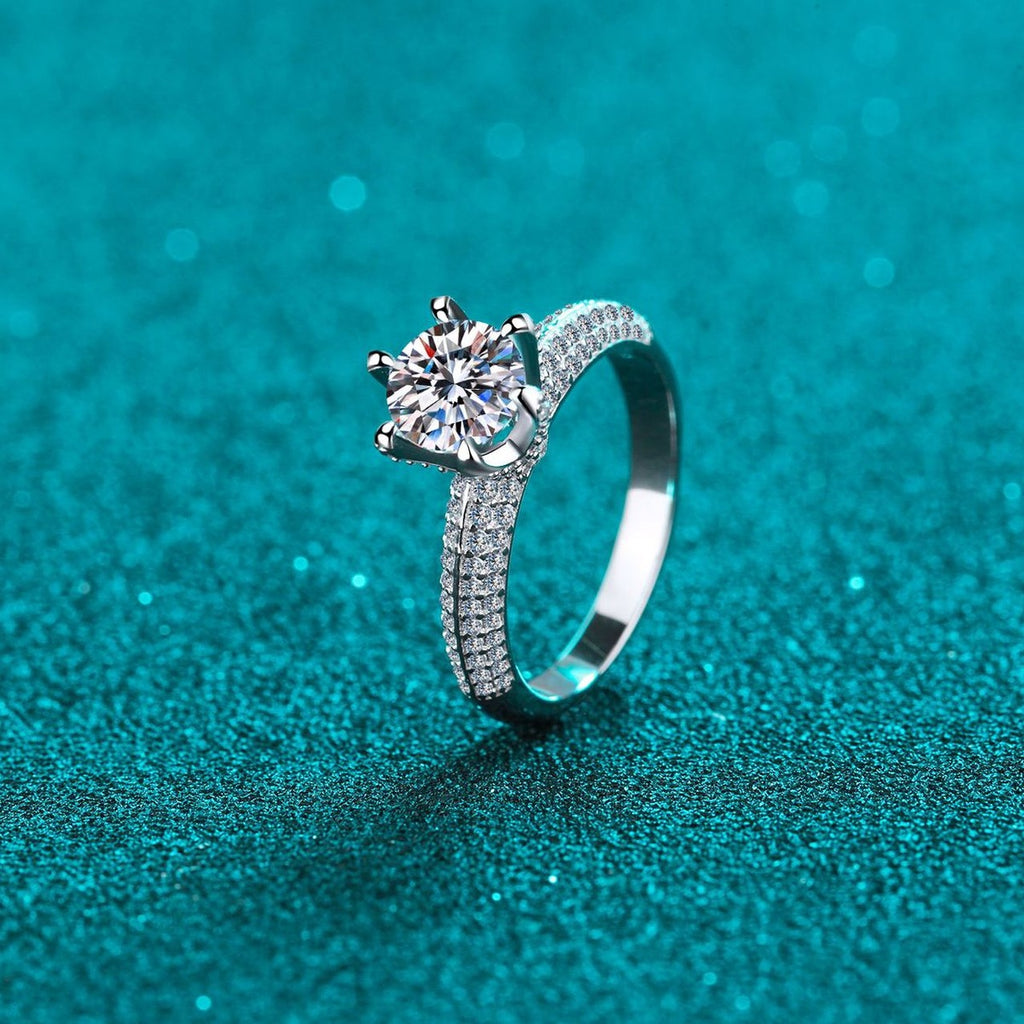 Round Moissanite Side Stone Ring with CZ in Rhodium-Plated S925 Sterling Silver blue display product photo showing the moissanite setting and band profile