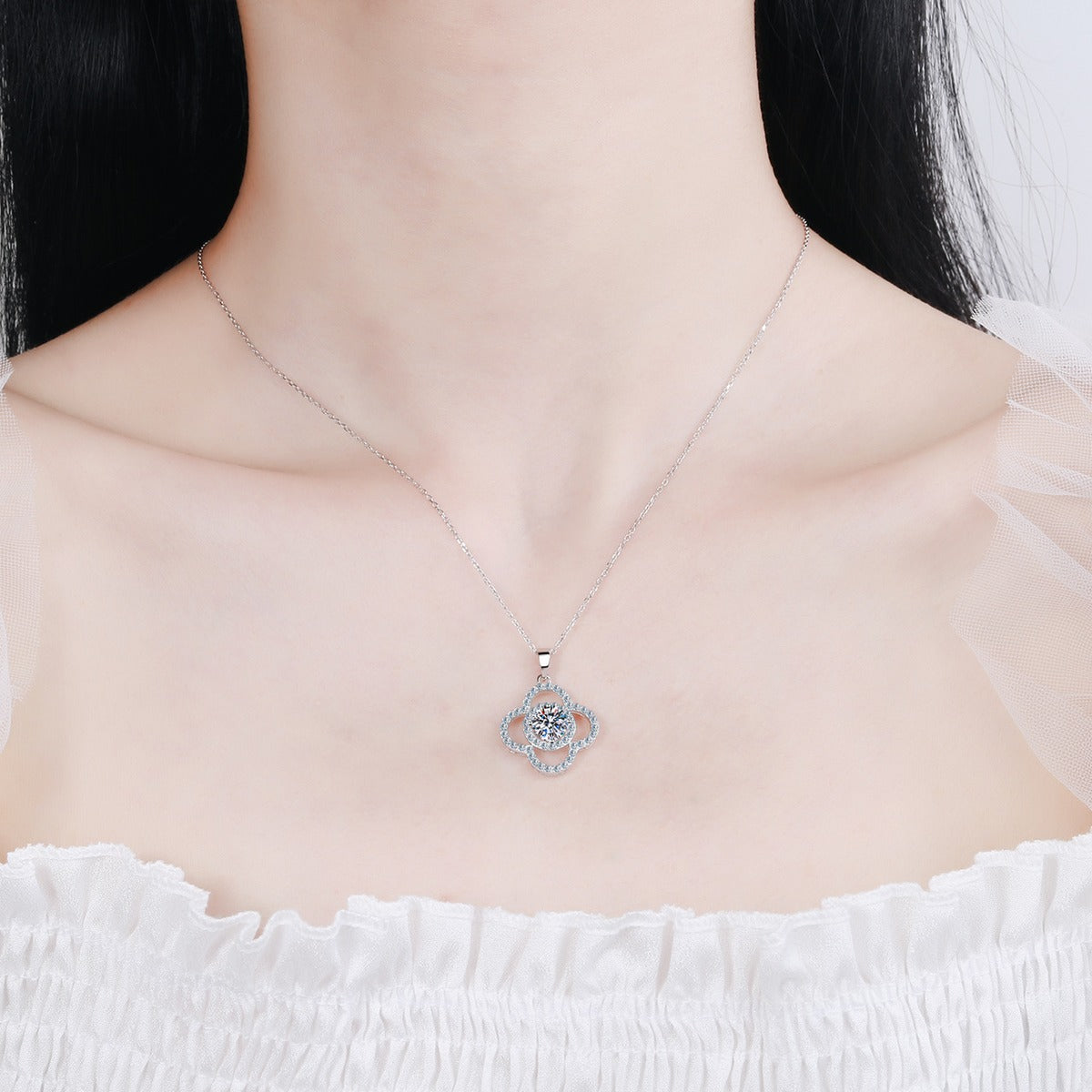 Clover Moissanite Pendant Necklace with CZ in Rhodium-Plated S925 sterling silver worn on neckline by model showing scale and adjustable chain styling