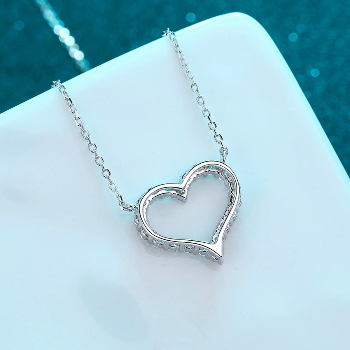 Heart Pave Moissanite Pendant Necklace in Rhodium-Plated S925 sterling silver product scene view showing angled sparkle