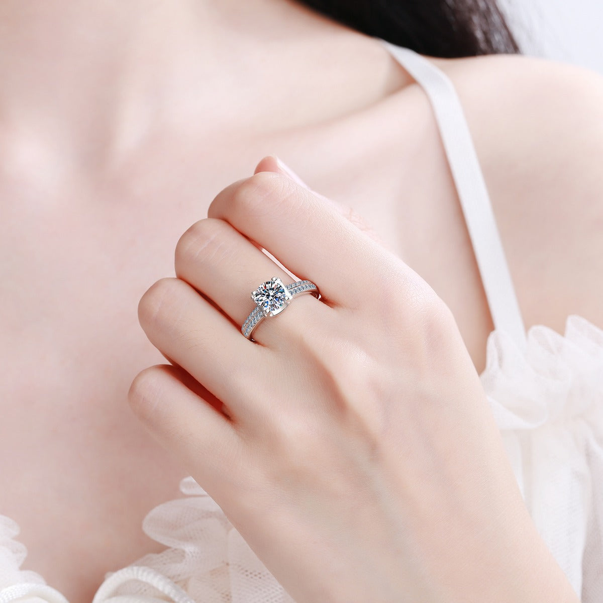 Round Moissanite Side Stone Engagement Ring with CZ worn on hand to show scale, band width, and ring profile