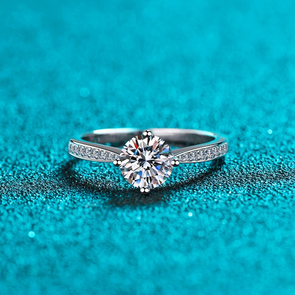 Round Moissanite Side Stone Engagement Ring with CZ product view showing moissanite setting and metal finish