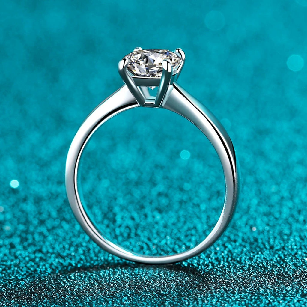 Round Moissanite Solitaire Ring in Rhodium-Plated S925 Sterling Silver blue display product photo showing the moissanite setting and band profile