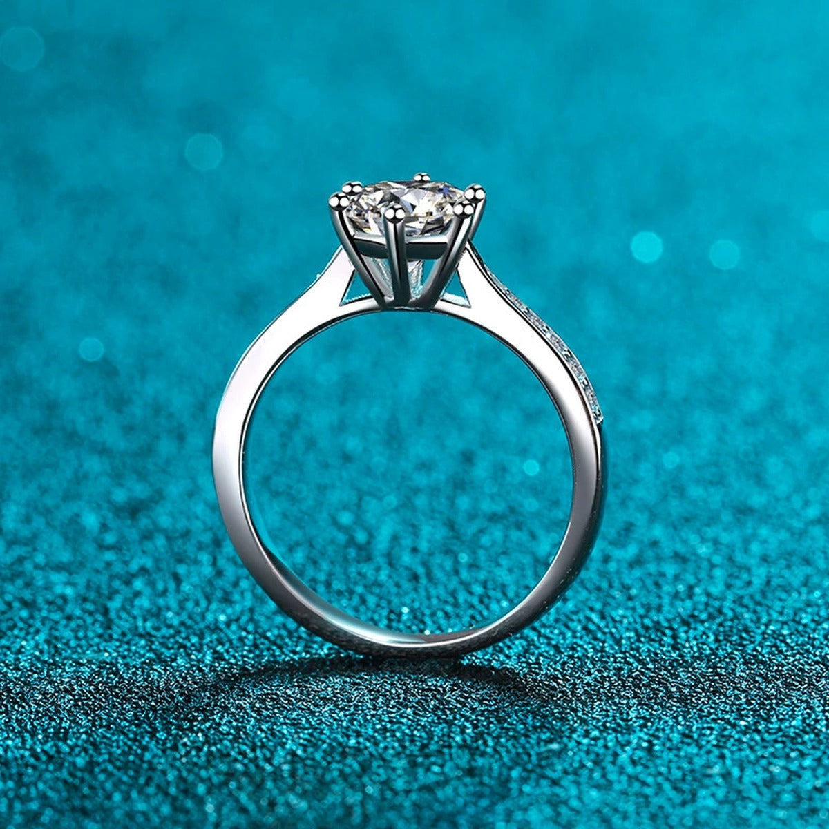Round Moissanite Side Stone Ring with CZ in Rhodium-Plated S925 Sterling Silver blue display product photo showing the moissanite setting and band profile