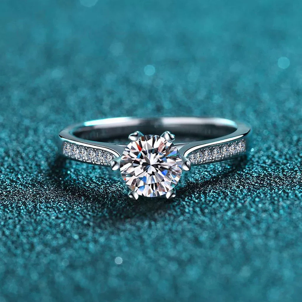 Round Moissanite Side Stone Engagement Ring with CZ product view showing moissanite setting and metal finish