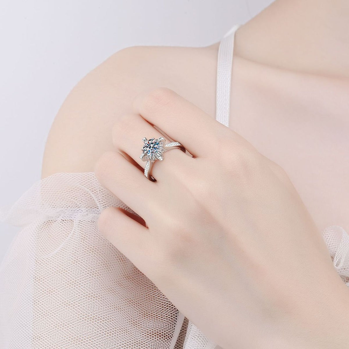 Round Floral Halo Moissanite Ring with CZ worn on hand to show scale, band width, and ring profile
