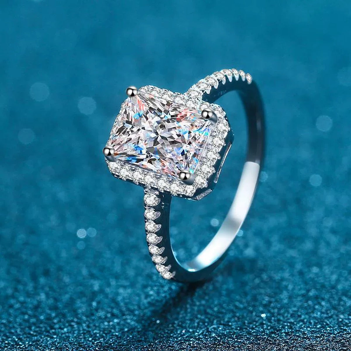 Radiant and Emerald Cut Moissanite Ring with CZ in Rhodium-Plated S925 Sterling Silver blue display product photo showing the moissanite setting and band profile