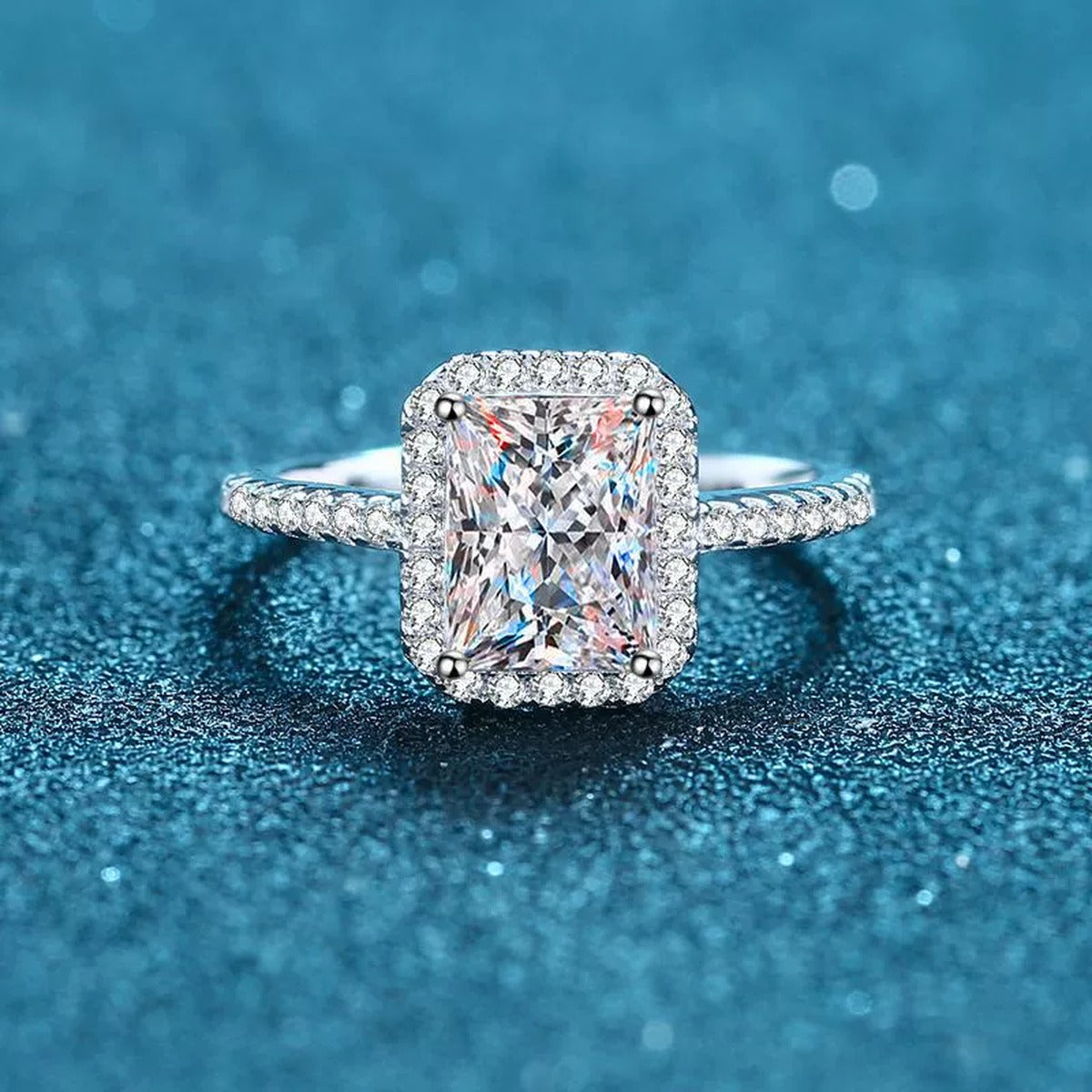 Radiant and Emerald Cut Moissanite Ring with CZ in Rhodium-Plated S925 Sterling Silver blue display product photo showing the moissanite setting and band profile