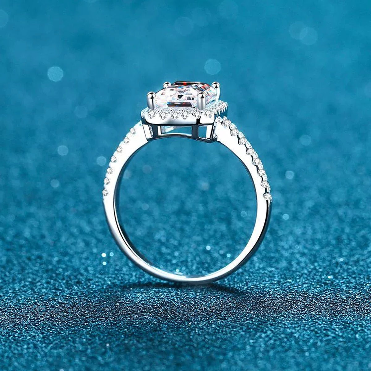 Radiant and Emerald Cut Moissanite Ring with CZ in Rhodium-Plated S925 Sterling Silver blue display product photo showing the moissanite setting and band profile