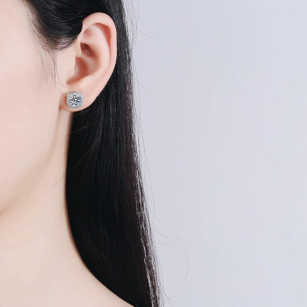 Cushion Halo Moissanite Stud Earrings with CZ in Rhodium-Plated S925 sterling silver worn on ear by model showing scale, placement, and stud earrings styling