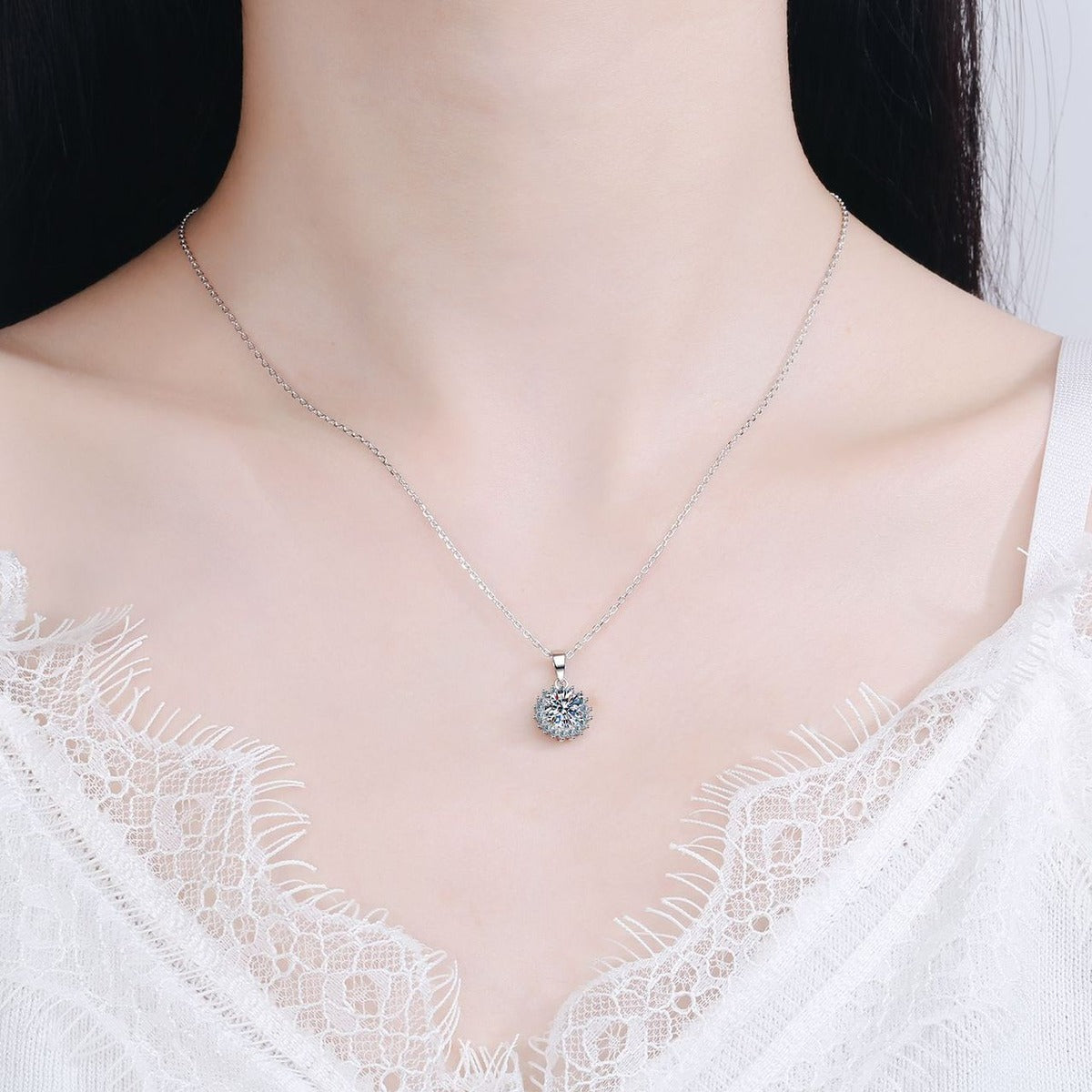 Sunburst Moissanite Pendant Necklace with CZ in Rhodium-Plated S925 sterling silver worn on neckline by model showing scale and adjustable chain styling