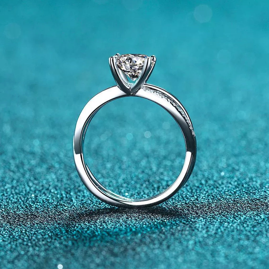 Round Moissanite Side Stone Ring with CZ in Rhodium-Plated S925 Sterling Silver blue display product photo showing the moissanite setting and band profile