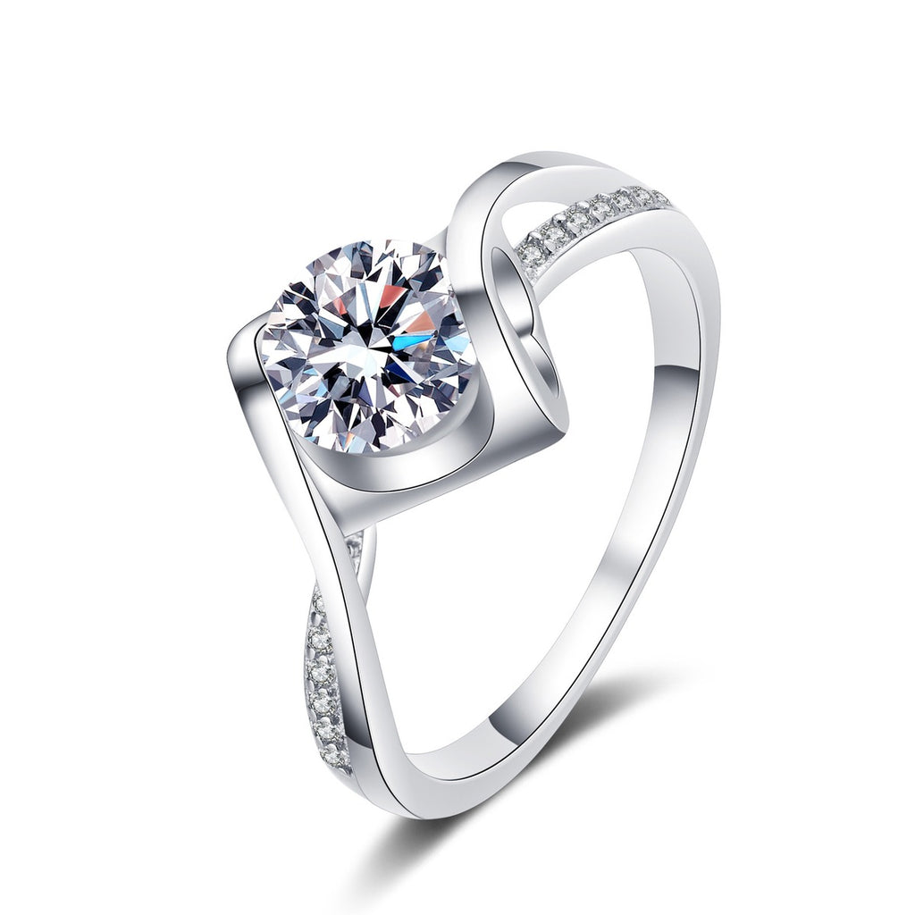 Round Moissanite Side Stone Ring with CZ in Rhodium-Plated S925 Sterling Silver clean white background product photo showing the ring silhouette and moissanite setting