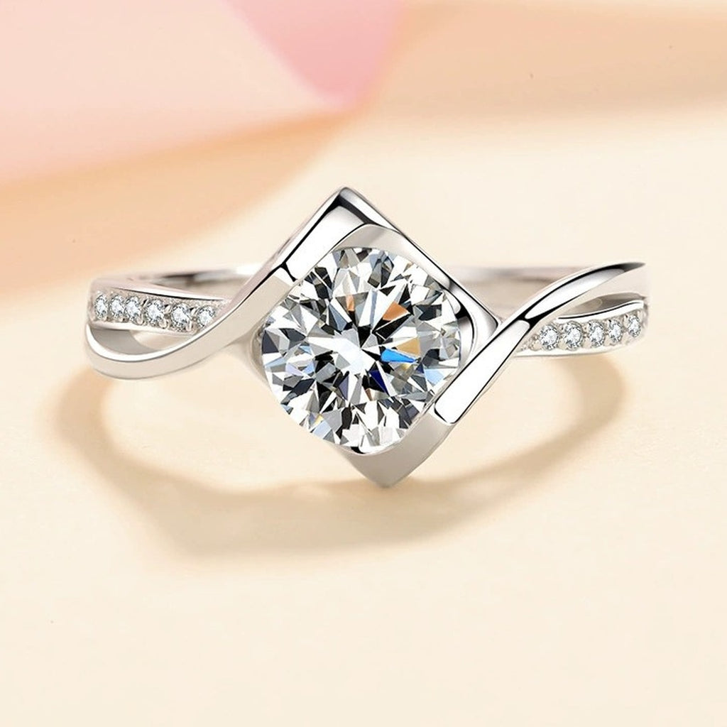 Round Moissanite Side Stone Ring with CZ in Rhodium-Plated S925 Sterling Silver studio product angle showing the ring setting, stone detail, and band design