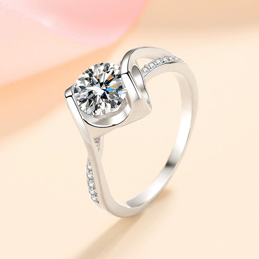 Round Moissanite Side Stone Ring with CZ in Rhodium-Plated S925 Sterling Silver studio product angle showing the ring setting, stone detail, and band design