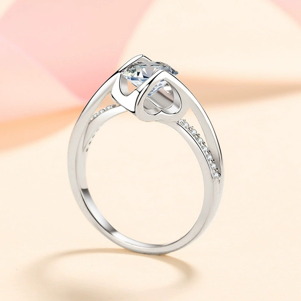 Round Moissanite Side Stone Ring with CZ in Rhodium-Plated S925 Sterling Silver studio product angle showing the ring setting, stone detail, and band design