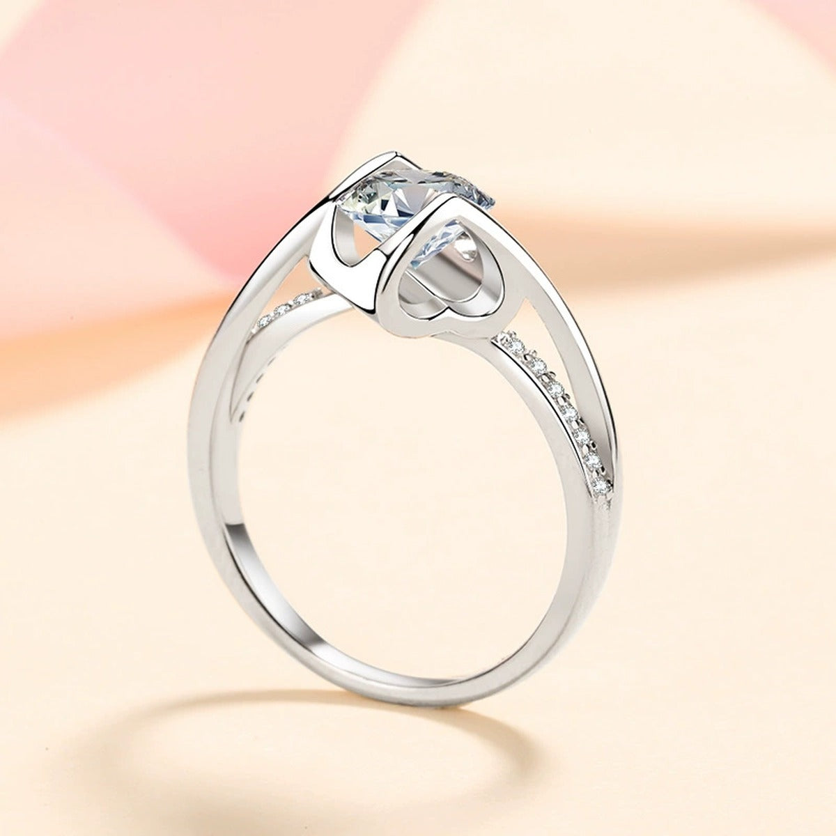 Round Moissanite Side Stone Ring with CZ in Rhodium-Plated S925 Sterling Silver studio product angle showing the ring setting, stone detail, and band design