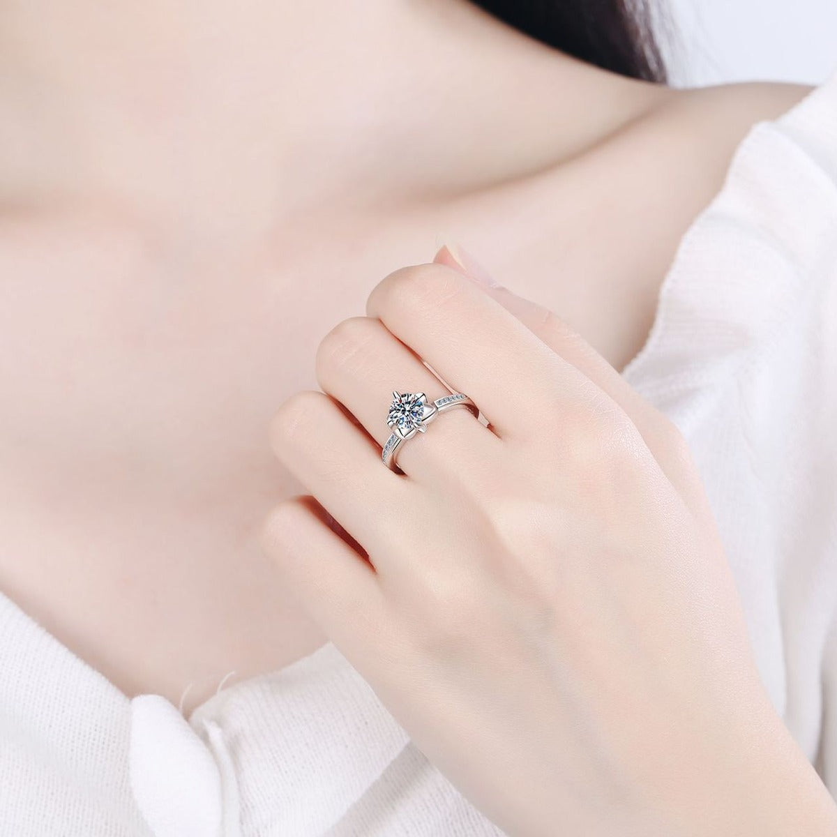 Round Moissanite Adjustable Side Stone Ring with CZ worn on hand to show scale, band width, and ring profile