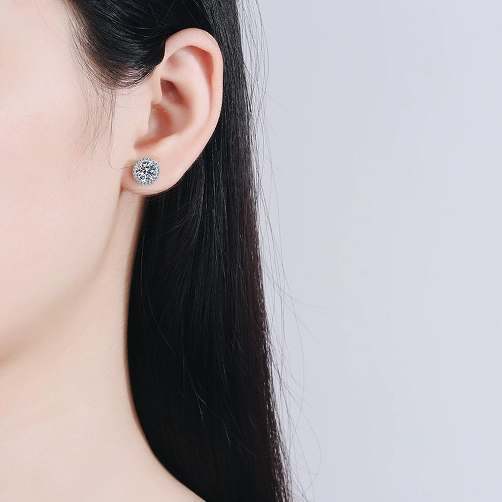 Round Halo Moissanite Stud Earrings with CZ in Rhodium-Plated S925 sterling silver worn on ear by model showing scale, placement, and stud earrings styling