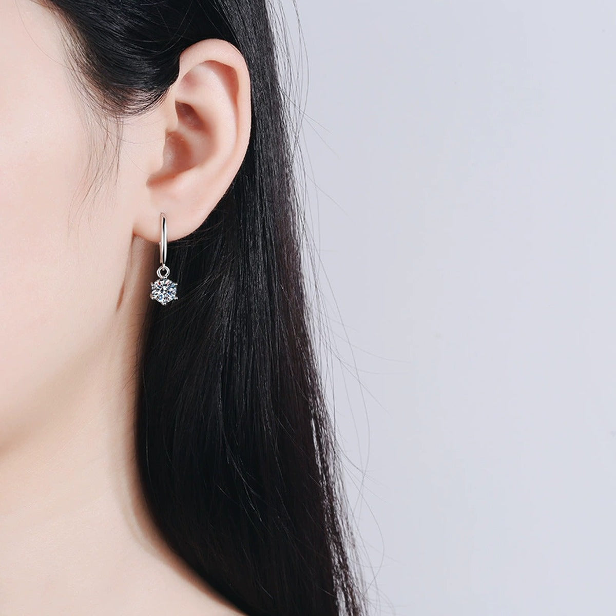 Round Moissanite Hook Dangle Earrings in Rhodium-Plated S925 sterling silver worn on ear by model showing scale, placement, and hook dangle earrings styling