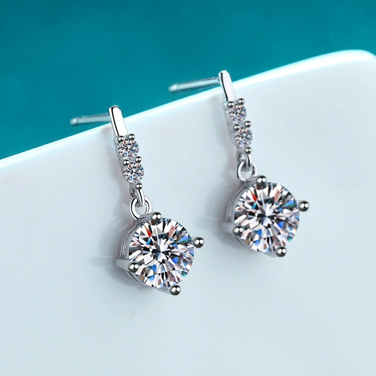 Round Moissanite Stud Dangle Earrings with CZ in Rhodium-Plated S925 sterling silver product scene view showing front sparkle