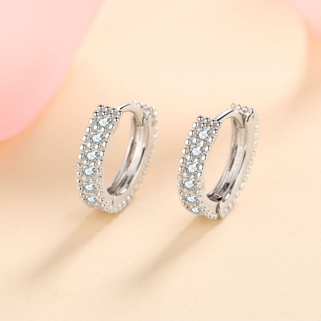 Pavé Moissanite Huggie Hoop Earrings in Rhodium-Plated S925 sterling silver product scene view showing angled setting detail