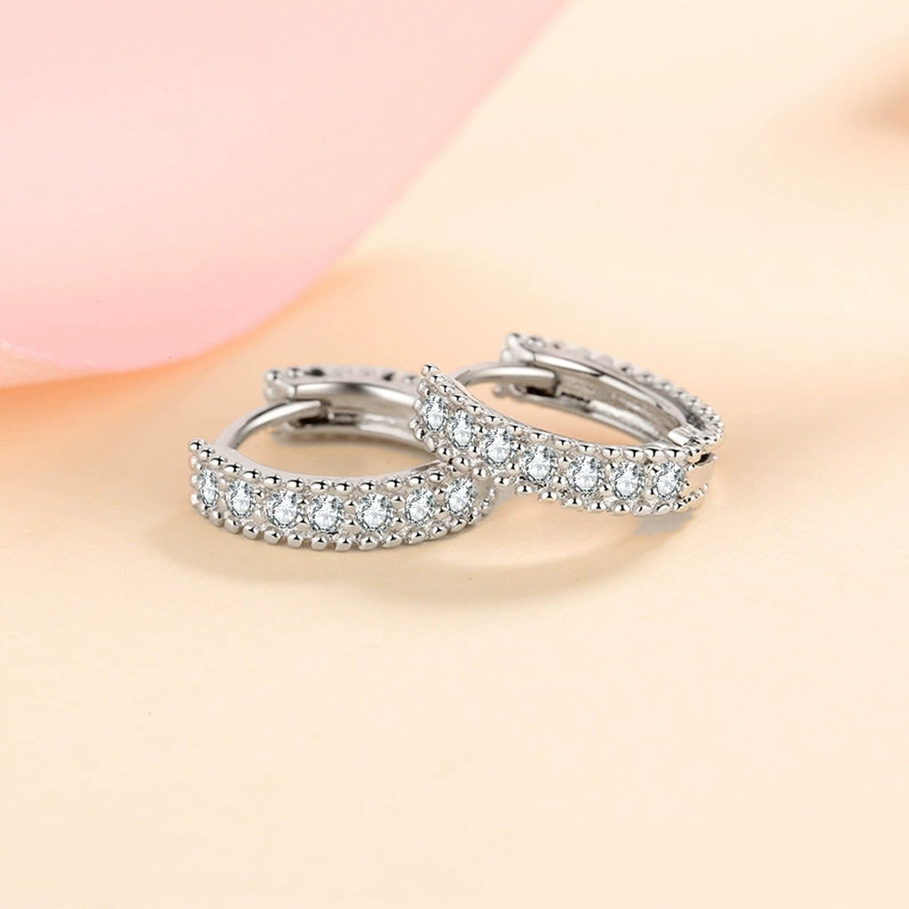 Pavé Moissanite Huggie Hoop Earrings in Rhodium-Plated S925 sterling silver product scene view showing side profile