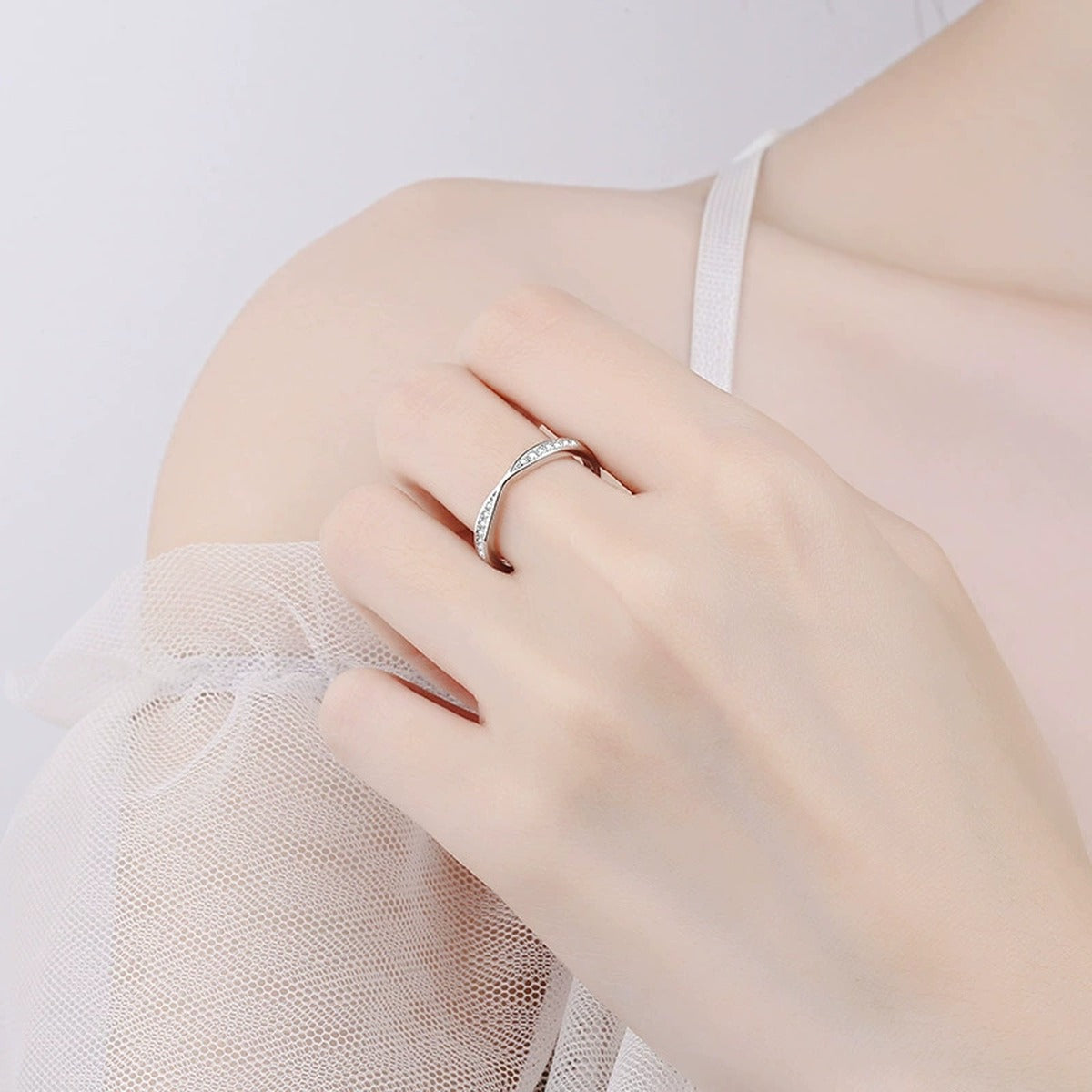 Round Moissanite Ring in Rhodium-Plated S925 Sterling Silver worn on hand, showing scale, finger coverage, and rhodium-plated finish