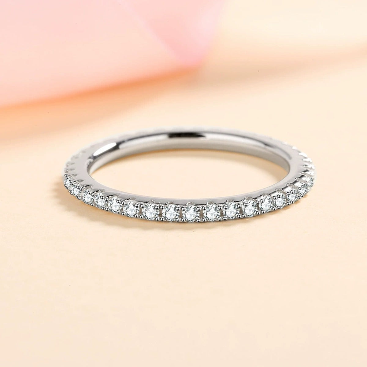Moissanite Eternity Band Ring in Rhodium-Plated S925 Sterling Silver studio product angle showing the ring setting, stone detail, and band design