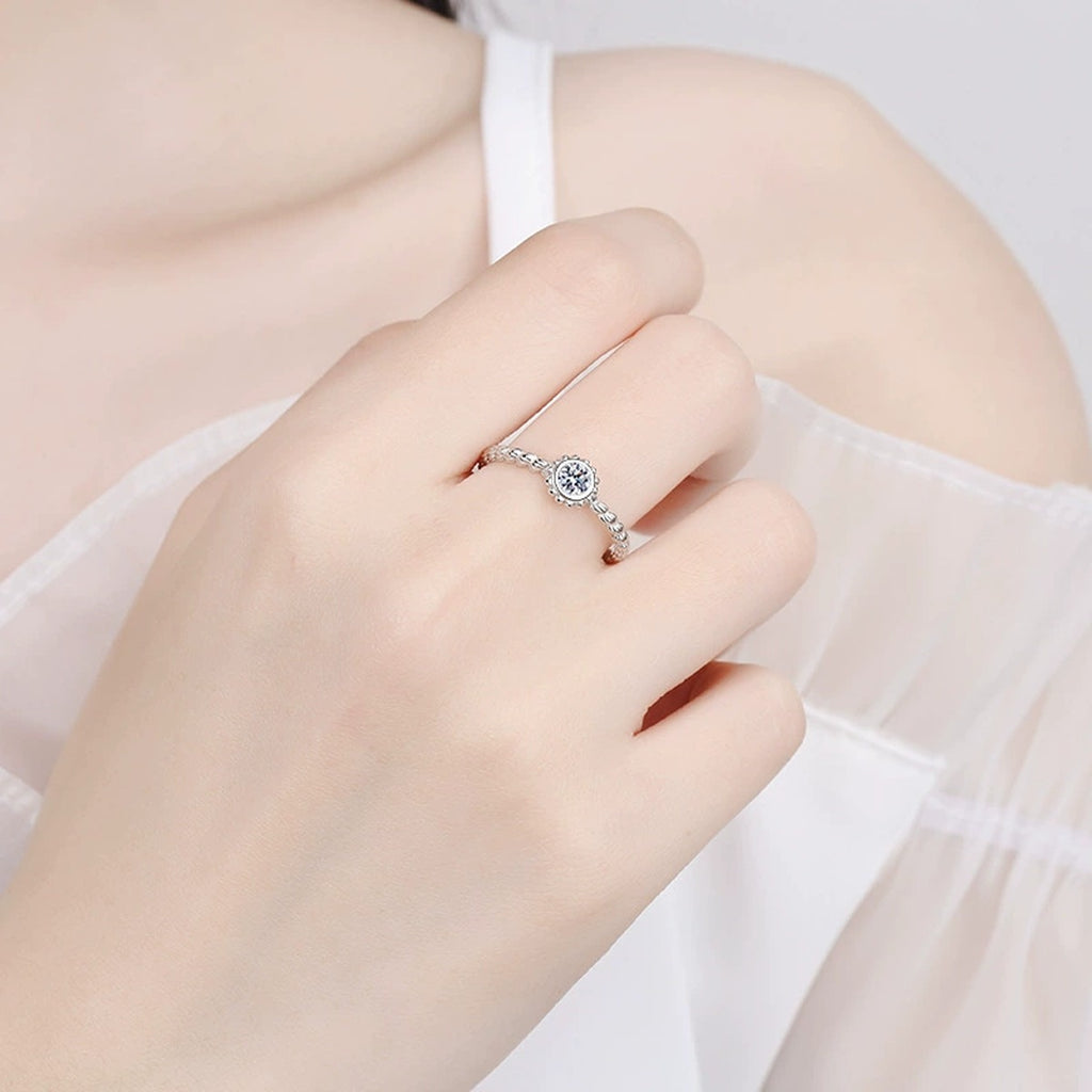 Bezel Moissanite Band Ring in Rhodium-Plated S925 Sterling Silver worn on hand, showing scale, finger coverage, and rhodium-plated finish
