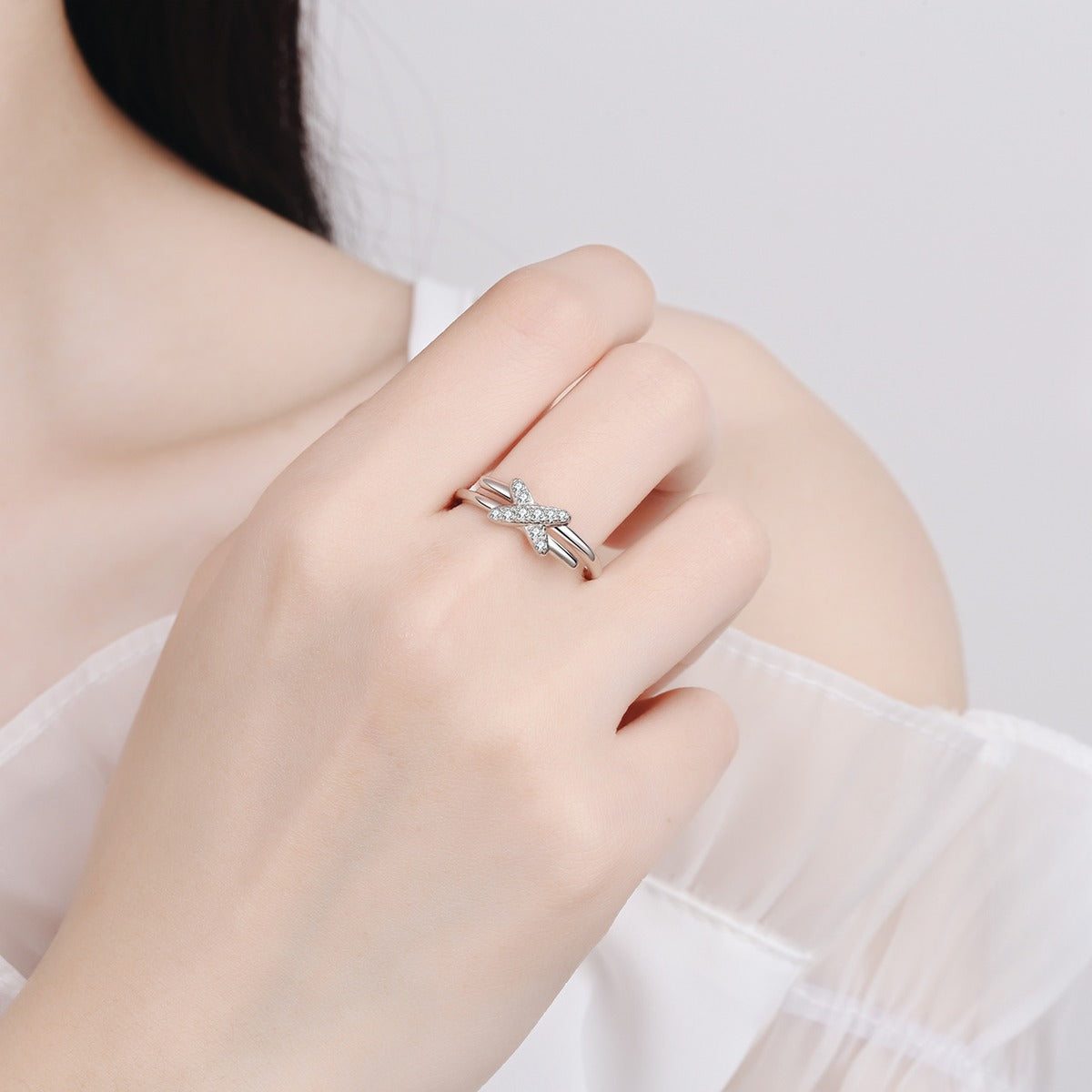 Round Moissanite X Ring worn on hand to show scale, band width, and ring profile