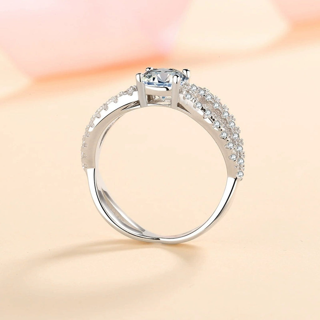 Round Moissanite Side Stone Engagement Ring with CZ worn on hand to show scale, band width, and ring profile