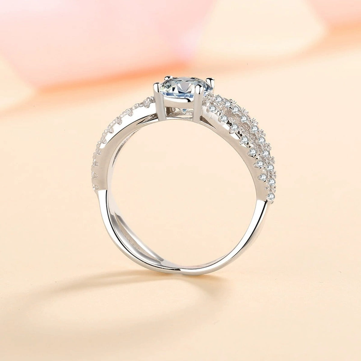 Round Moissanite Side Stone Engagement Ring with CZ worn on hand to show scale, band width, and ring profile