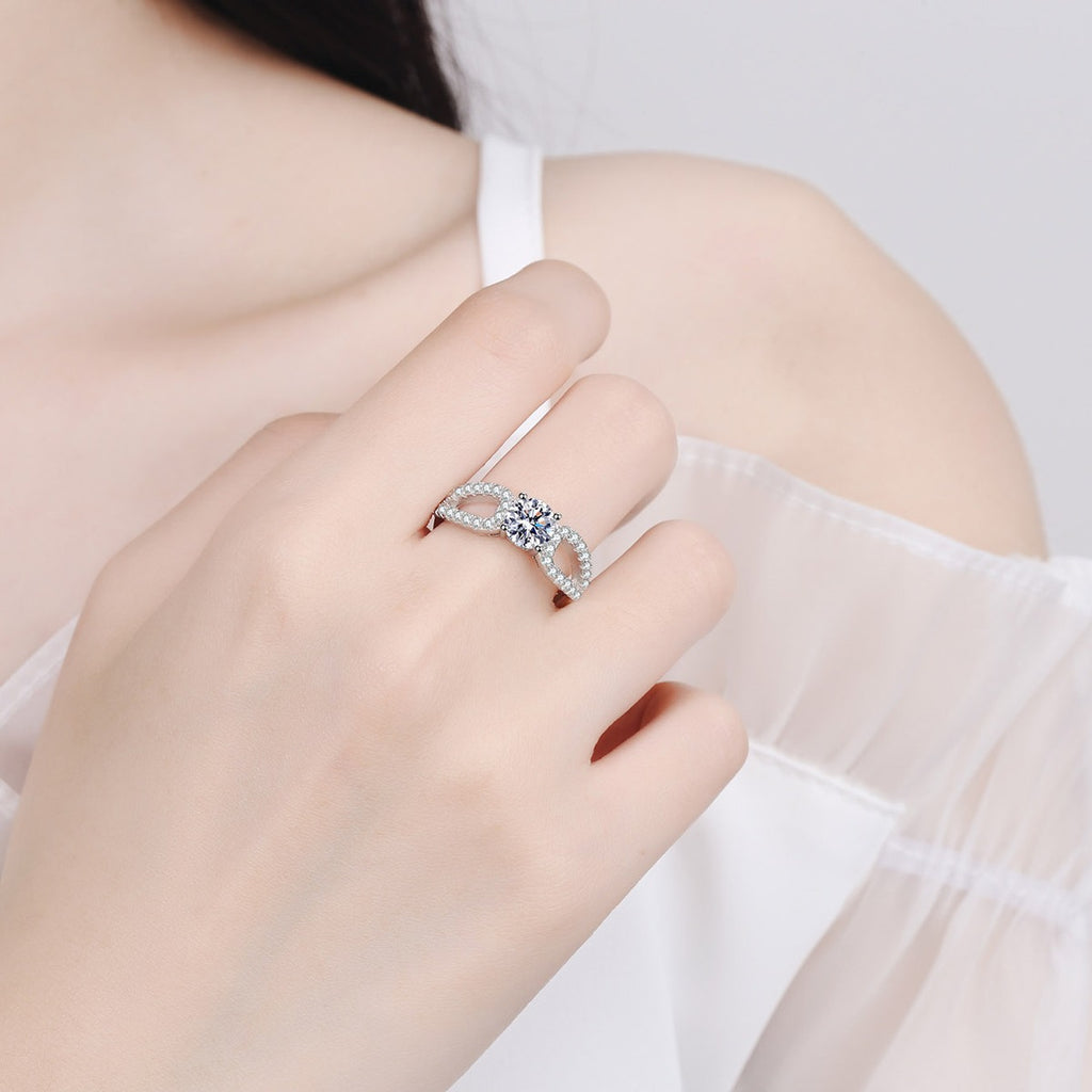 Round Moissanite Side Stone Engagement Ring with CZ worn on hand to show scale, band width, and ring profile