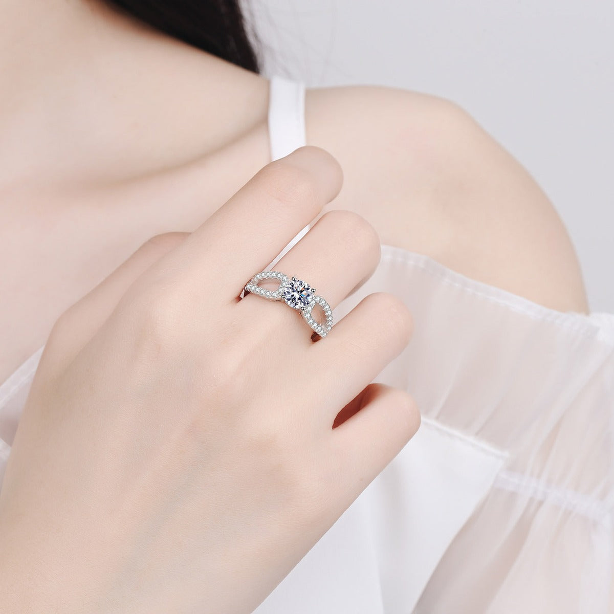Round Moissanite Side Stone Engagement Ring with CZ worn on hand to show scale, band width, and ring profile