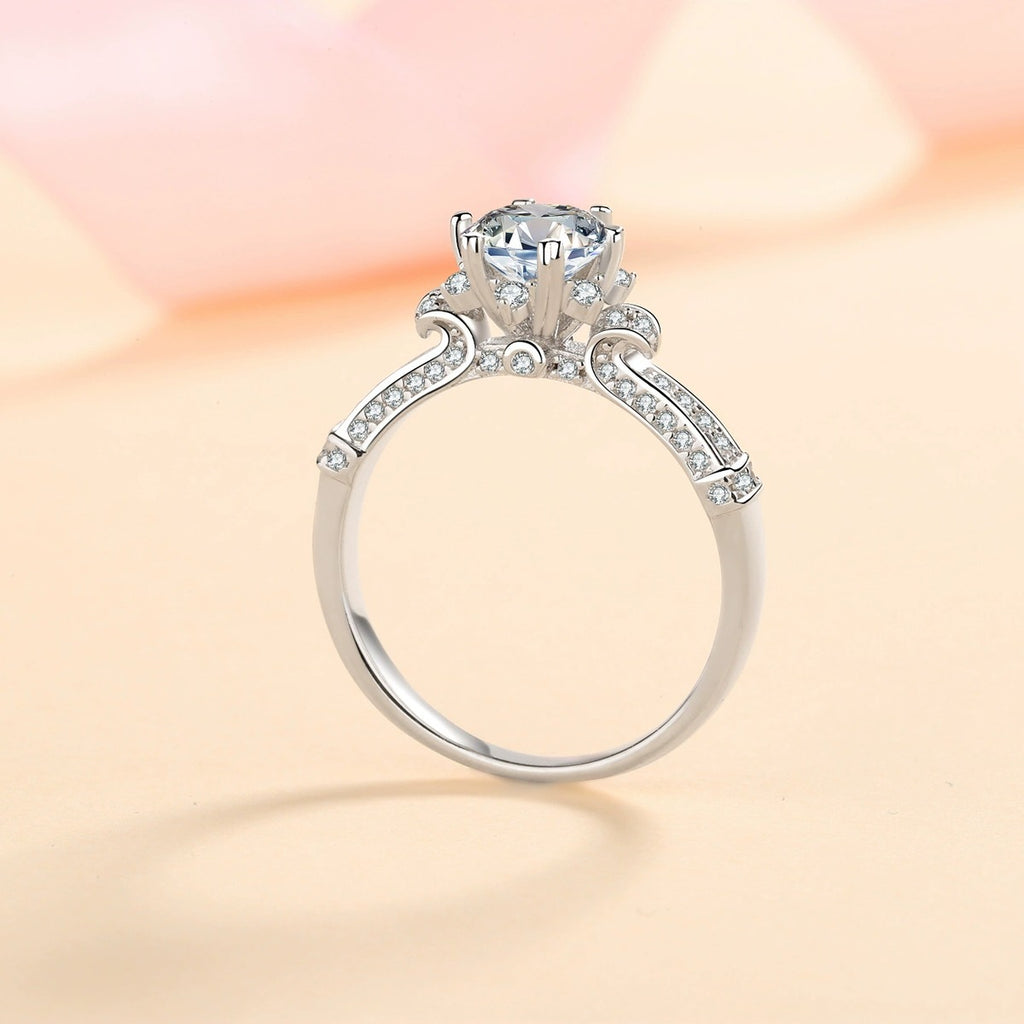 Round Moissanite Side Stone Ring with CZ product view showing moissanite setting and metal finish