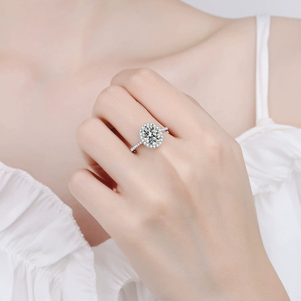 Oval Moissanite Ring with CZ in Rhodium-Plated S925 Sterling Silver worn on hand, showing scale, finger coverage, and rhodium-plated finish