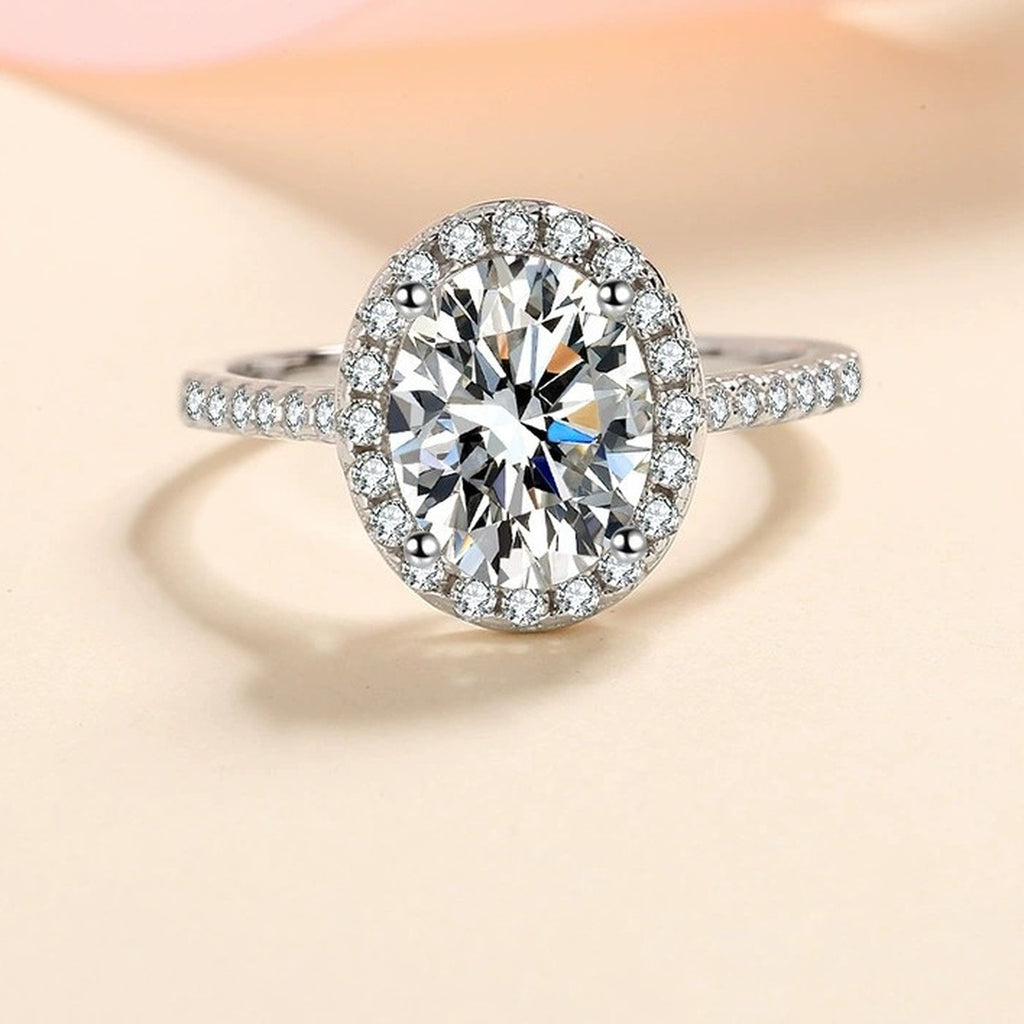 Oval Moissanite Ring with CZ in Rhodium-Plated S925 Sterling Silver studio product angle showing the ring setting, stone detail, and band design