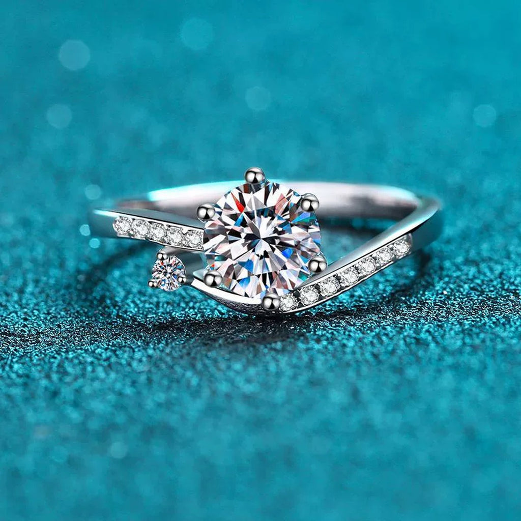 Round Moissanite Side Stone Ring with CZ in Rhodium-Plated S925 Sterling Silver blue display product photo showing the moissanite setting and band profile