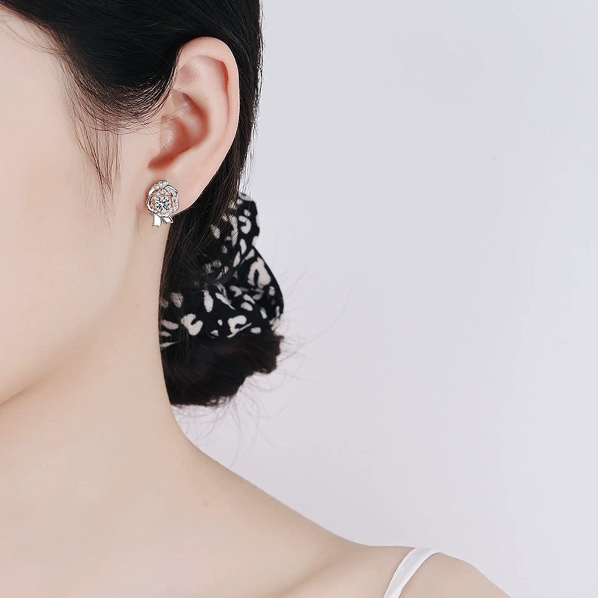 Round Moissanite Stud Earrings with CZ in Rhodium and Champion Gold-Plated S925 sterling silver worn on ear by model showing scale, placement, and stud earrings styling