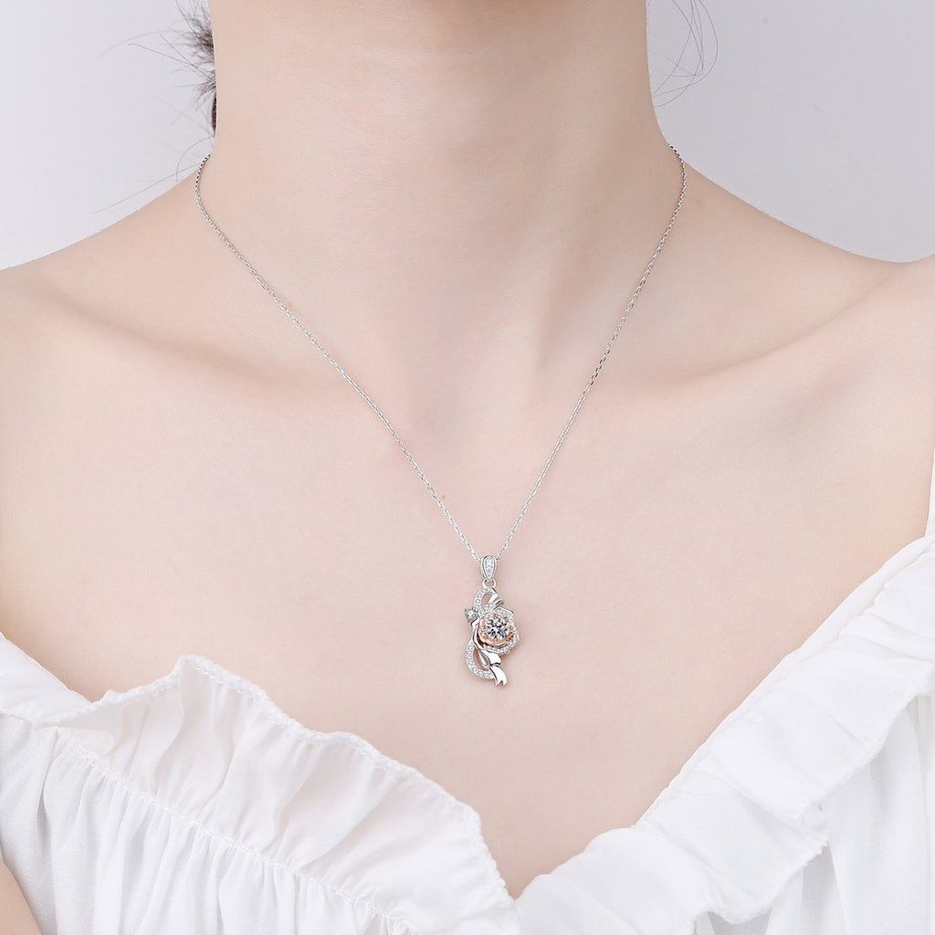 Bow Rose Moissanite Pendant Necklace with CZ in Rhodium and Rose Gold-Plated S925 sterling silver worn on neckline by model showing scale and adjustable chain styling