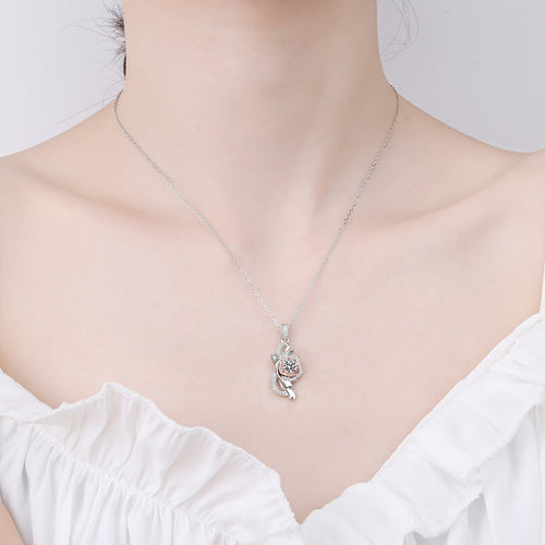 Bow Rose Moissanite Pendant Necklace with CZ in Rhodium and Rose Gold-Plated S925 sterling silver worn on neckline by model showing scale and adjustable chain styling