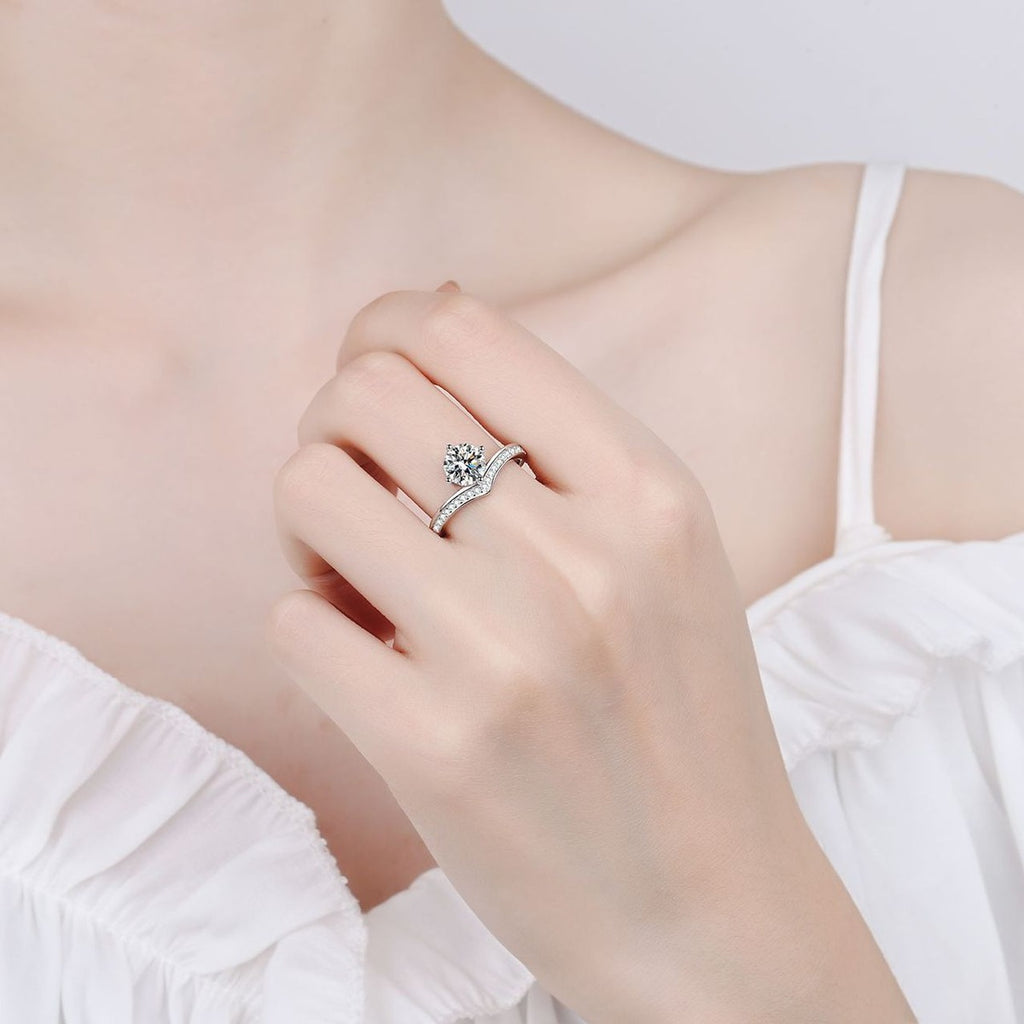 Round Moissanite Side Stone Engagement Ring with CZ worn on hand to show scale, band width, and ring profile
