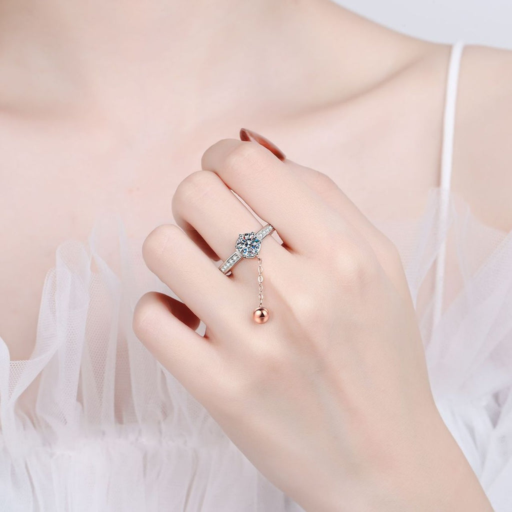 Round Moissanite Side Stone Engagement Ring with CZ worn on hand to show scale, band width, and ring profile
