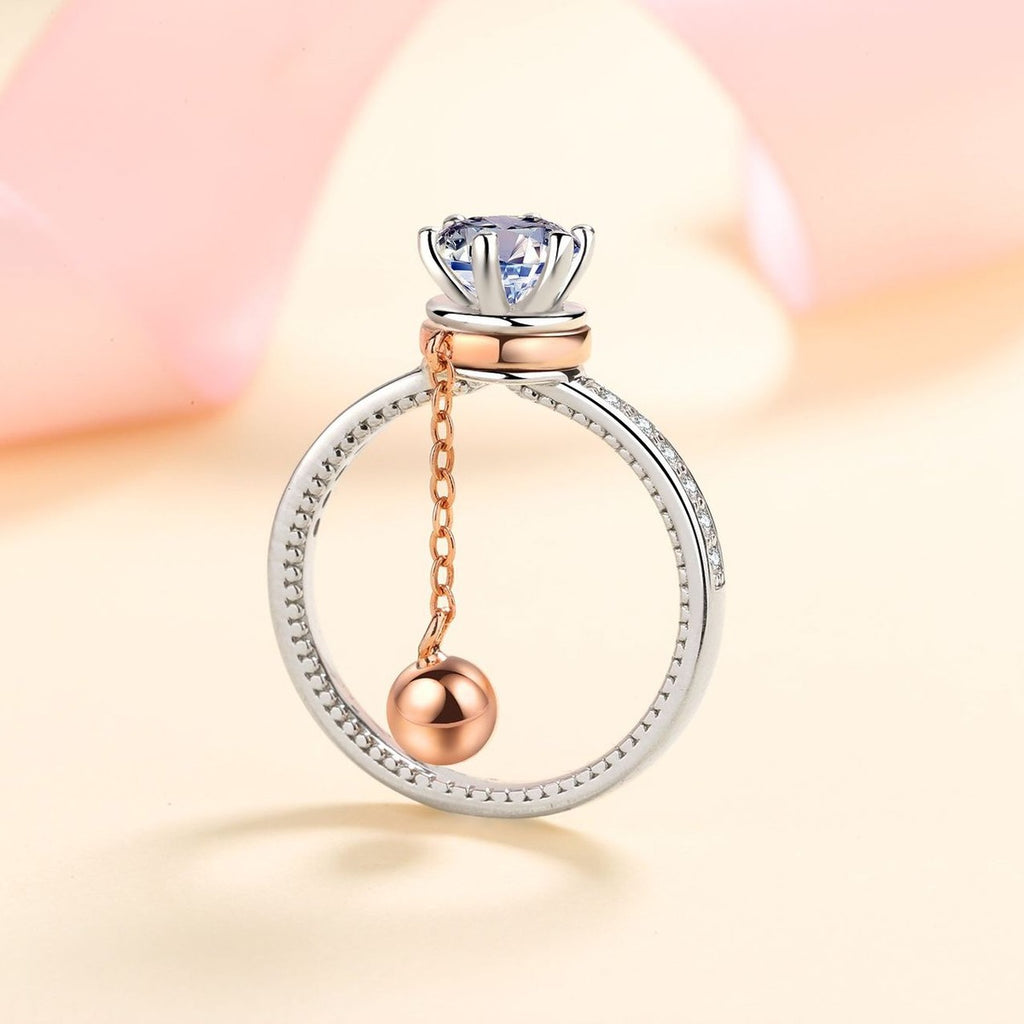 Round Moissanite Side Stone Engagement Ring with CZ worn on hand to show scale, band width, and ring profile