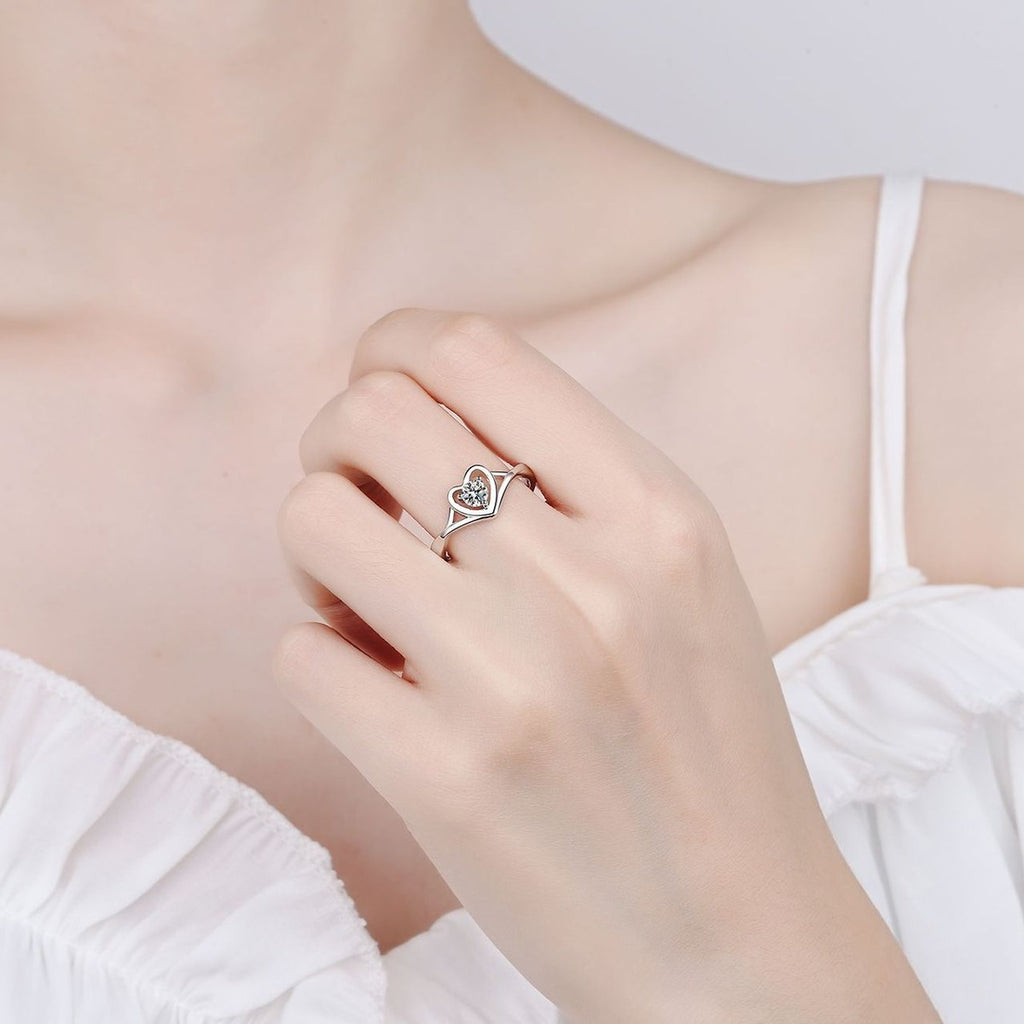 Round Moissanite Heart Promise Ring worn on hand to show scale, band width, and ring profile