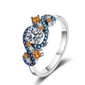 Round Moissanite Statement Ring with Blue and Orange CZ in rhodium-plated S925 sterling silver on clean white background