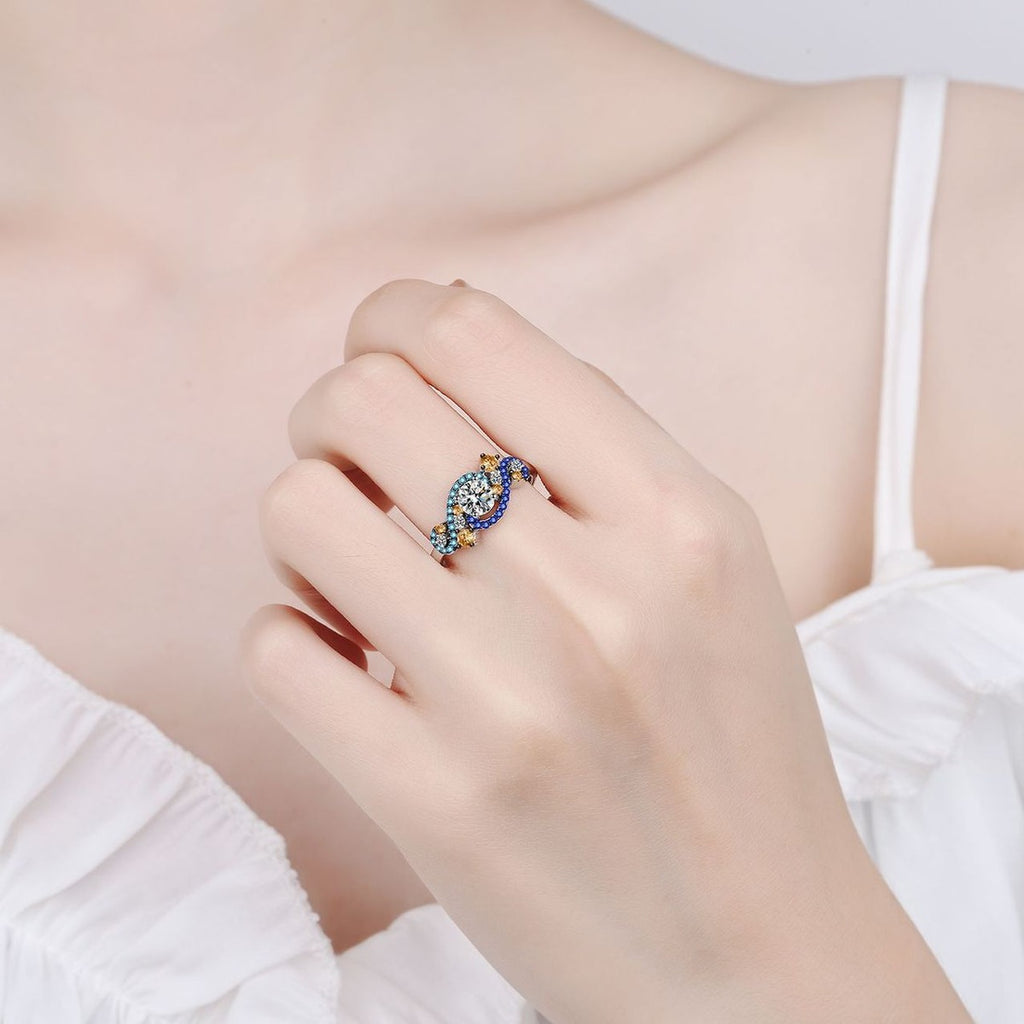 Round Moissanite Statement Ring with Blue and Orange CZ worn on hand to show scale, band width, and ring profile