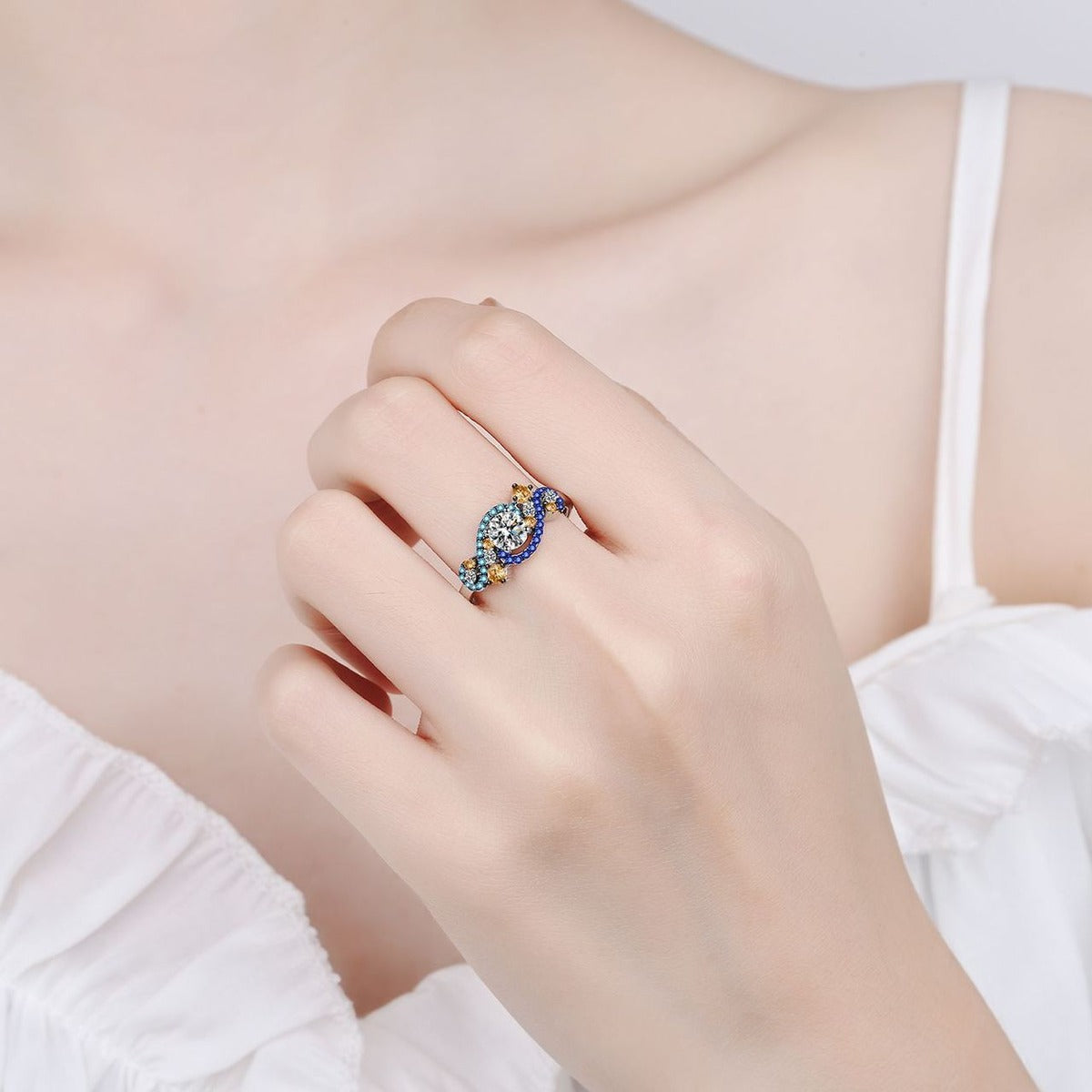 Round Moissanite Statement Ring with Blue and Orange CZ worn on hand to show scale, band width, and ring profile