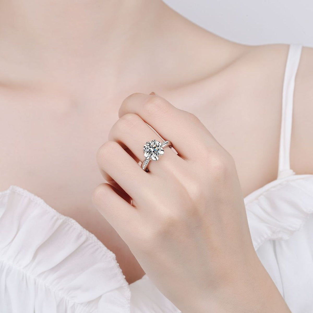 Round Moissanite Halo Engagement Ring with CZ worn on hand to show scale, band width, and ring profile
