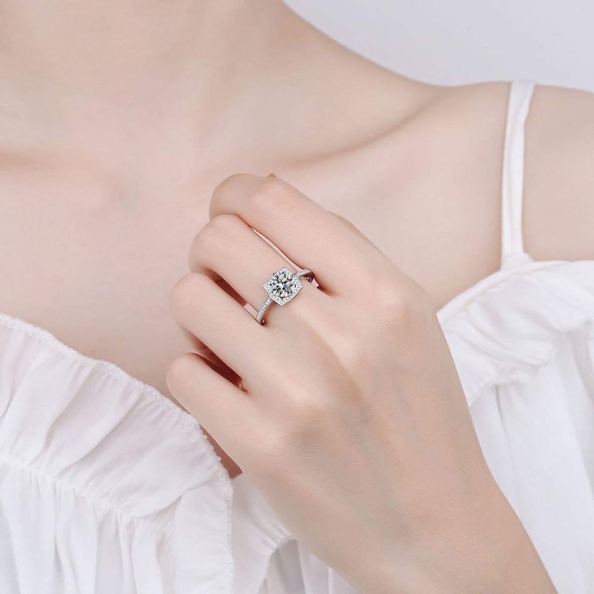 Round Moissanite Halo Engagement Ring with CZ worn on hand to show scale, band width, and ring profile